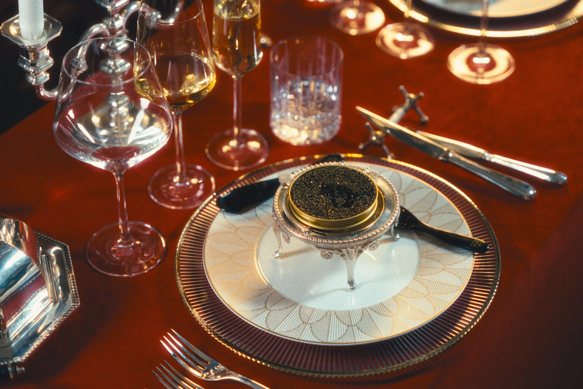 Imperial Ossetra at a deep red table with champagne